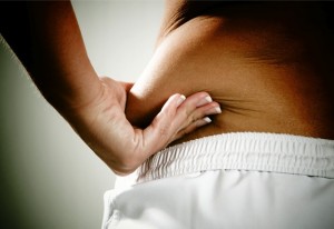 Women pulling fat on lower back.